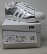 A pair of as new Prada Adidas Superstar sneakers (UK 9).