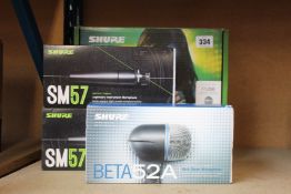 A Shure BLX24E/PG58-S8 Wireless Vocal System, two Shure SM57 Dynamic Instrument Microphones and a