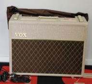 A VOX AC30HW3X Hand Wired Series guitar amplifier with a single button foot switch.