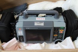 A Lifepak 15 Defibrillator with some accessories.