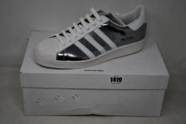 A pair of as new Prada Adidas Superstar sneakers (UK 9.5).