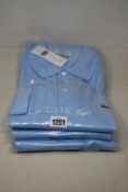 Three as new Lacoste polo shirts in powder blue (FR 4/US M - RRP £95 each).