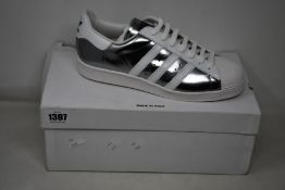 A pair of as new Prada Adidas Superstar sneakers (UK 8).