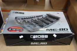 A Boss ME-80 multi guitar effects pedal (Box damaged).