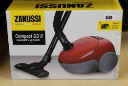 A new Zanussi Compact Go ll Red, 750W, 1.5L, 5M automatic cord rewind vacuum cleaner.