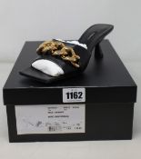 A pair of as new Versace mules in black (IT 37.5 - RRP £710).