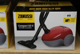 A new Zanussi Compact Go ll Red, 750W, 1.5L, 5M automatic cord rewind vacuum cleaner.