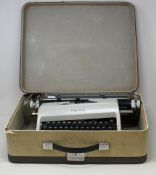 A pre-owned vintage Olympia typewriter (Some damage, item untested).