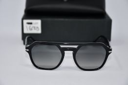 A pair of as new Persol PO3206S sunglasses.