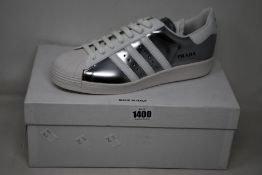 A pair of as new Prada Adidas Superstar sneakers (UK 9.5).