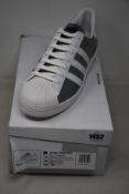 A pair of as new Prada Adidas Superstar sneakers (UK 11.5).
