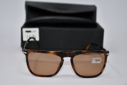 A pair of as new Persol PO3225S sunglasses.
