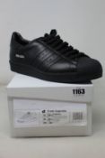 A pair of as new Prada Adidas Superstar sneakers (UK 10.5).