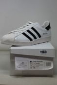 A pair of as new Prada Adidas Superstar sneakers (UK 12).