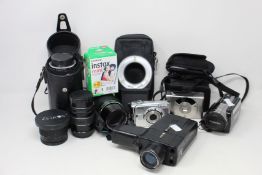 Two digital cameras, a Toshiba Camileo x100 digital video camera, a Halina vintage video camera