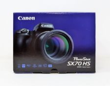 A boxed as new Canon PowerShot SX70HS Compact Digital Camera (Two pin plug included).