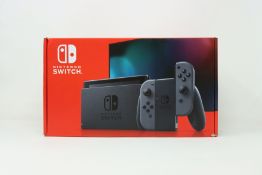 A boxed as new Nintendo Switch Console in Grey (M/N: HAD-S-KAAAA-JPN) (Some packaging text in