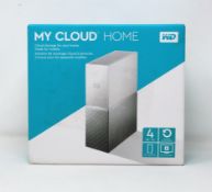 A boxed as new WD My Cloud Home 4TB NAS Drive (Box sealed, some damage to box).
