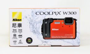 A boxed as new Nikon Coolpix W300 16.05MP Waterproof Digital Camera in Orange (2-Pin plug