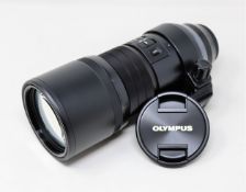 A boxed as new Olympus M.Zuiko Digital ED 300mm f4 IS PRO Lens in Black.