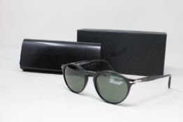 A pair of as new Persol sunglasses.