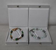 An as new Coeur De Lion Geo Cube Gree-Beige and Rose Bracelet 4905/30-0510 (RRP £95) and an as new