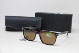 A pair of as new Persol sunglasses.