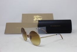A pair of as new Burberry sunglasses.