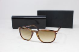 A pair of as new Persol sunglasses.