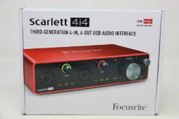 A boxed as new Scarlet 4i4 audio interface.