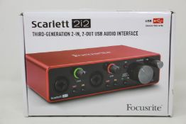 A boxed as new Scarlet 2i2 audio interface.