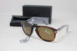 A pair of as new Persol folding sunglasses.