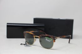 A pair of as new Persol sunglasses.