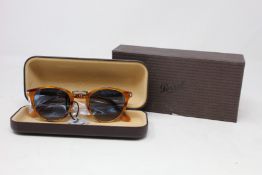 A pair of as new Persol sunglasses.