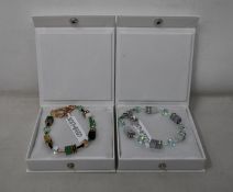 An as new Coeur De Lion Geo Cube Gree-Beige and Rose Bracelet 4905/30-0510 (RRP £95) and an as new