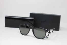A pair of as new Persol sunglasses.