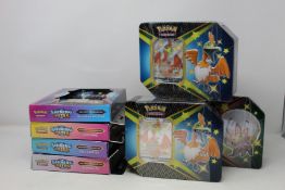 A quantity of Shining Fates Tins and Pin Collection boxes.