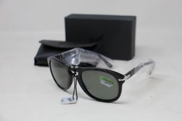 A pair of as new Persol folding sunglasses.