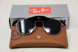 A pair of as new Ray Ban sunglasses.