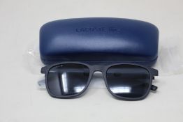 A pair of as new Lacoste sunglasses.