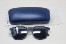 A pair of as new Lacoste sunglasses.