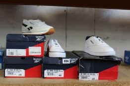 Four pairs of as new Reebok trainers; Club 85 (UK 11), Club C Coast (UK 7) and two pairs of