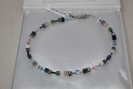 A boxed as new Coeur De Lion GeoCUBE Necklace with Swarovski crystals & gemstones in blue-green.