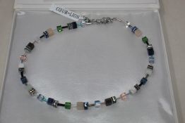 A boxed as new Coeur De Lion GeoCUBE Necklace with Swarovski crystals & gemstones in blue-green.