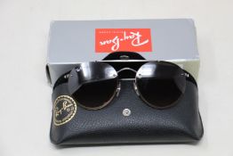 A pair of as new Ray Ban sunglasses.