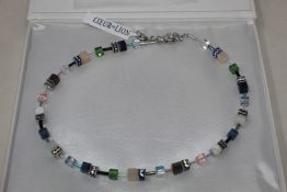 A boxed as new Coeur De Lion GeoCUBE Necklace with Swarovski crystals & gemstones in blue-green.