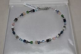 A boxed as new Coeur De Lion GeoCUBE Necklace with Swarovski crystals & gemstones in blue-green.