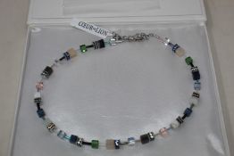A boxed as new Coeur De Lion GeoCUBE Necklace with Swarovski crystals & gemstones in blue-green.