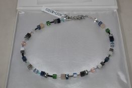 A boxed as new Coeur De Lion GeoCUBE Necklace with Swarovski crystals & gemstones in blue-green.