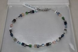 A boxed as new Coeur De Lion GeoCUBE Necklace with Swarovski crystals & gemstones in blue-green.